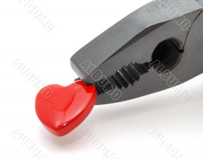 Heart in black pliers