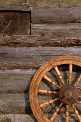 Spinning Wheel On The Log Hut Wall