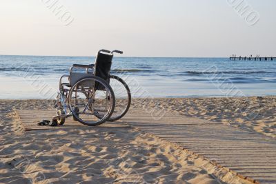 Wheelchair on sandy seacoast