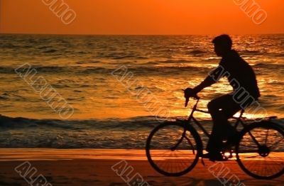 Cycling At Sunset On The Beach