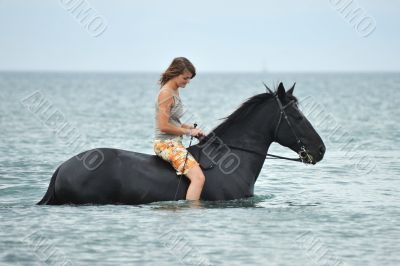 woman and  horse in the sea