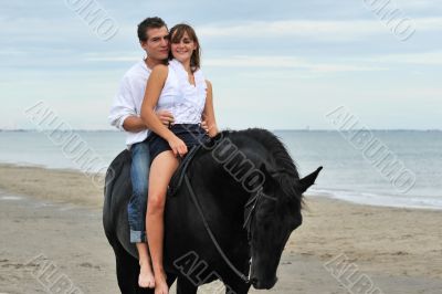couple and  horse on the beach
