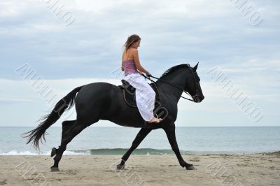 woman and  horse on the beach