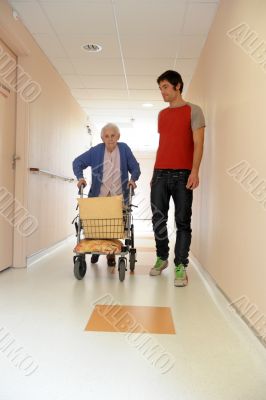 male nurse and senior woman with walking frame