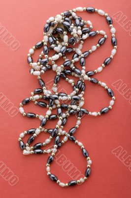 costume jewel beads on red macro