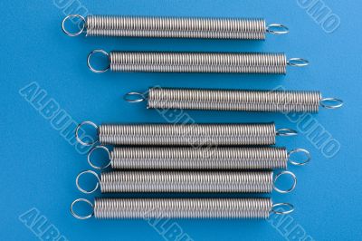 metal spring on blue background metal spring on blue background