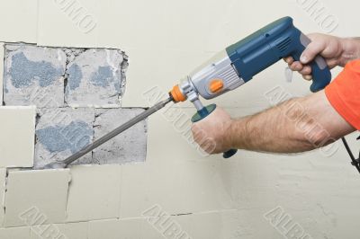 House-builder working with a perforator