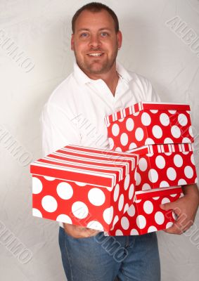 Adult Caucasian man with Christmas boxes