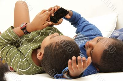 Two boys discovering a smart phone