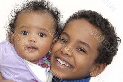 Young boy carrying his little sister