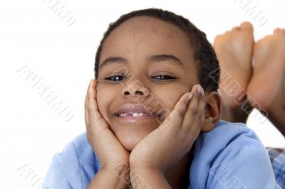 A young boy with his face resting on his hands
