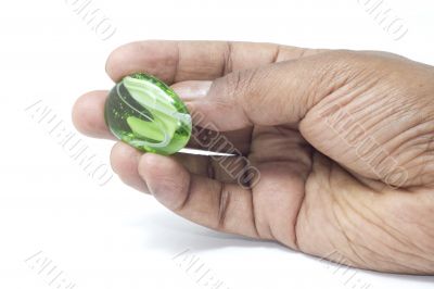 Hand holding a beautiful green marble