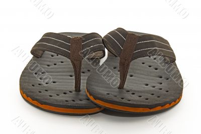 Brown flip flops on a white background