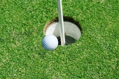 Golf Ball on green near hole