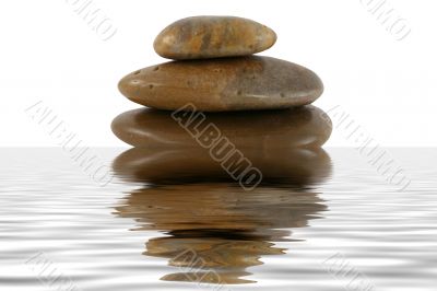 Stack of zen rocks with water reflection