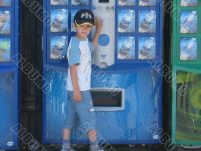  boy in front of beverage dispenser