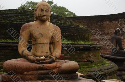 Seated Buddha Statues In The Rain