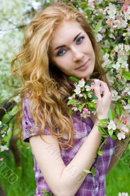 Red-headed woman under cherry tree