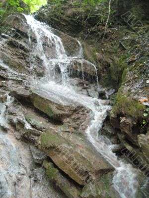 Waterfall flowing by the stones