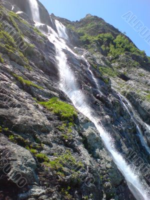 Waterfall flowing by the stones