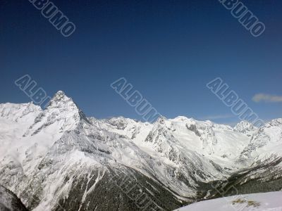 Mountain under the blue sky and the clouds