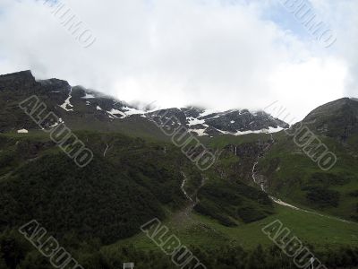 Mountain under the blue sky and the clouds