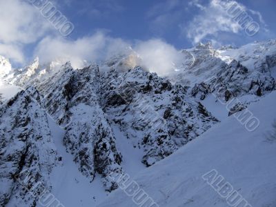 Mountain under the blue sky and the clouds