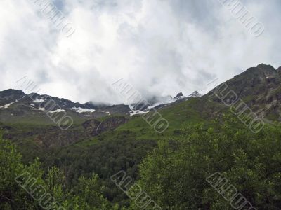 Mountain under the blue sky and the clouds
