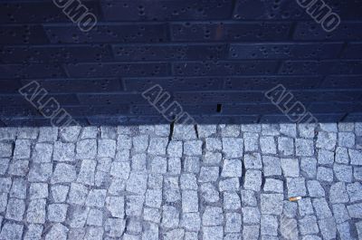 Single cigarette butt on cobble texture