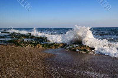 Sea wave is breaking on the rocks