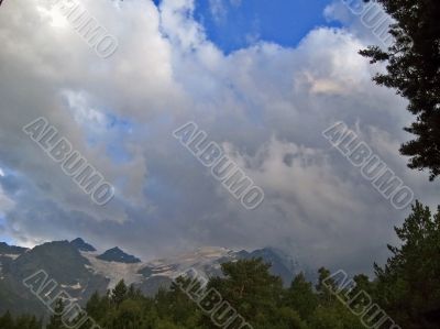 Mountain under the blue sky and the clouds