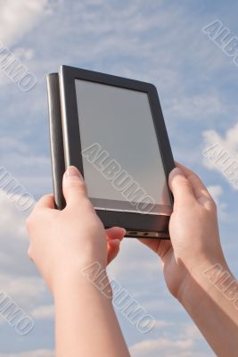 Hands hold electronic book reader Hands hold electronic book reader