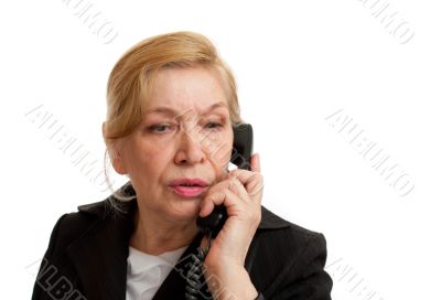 Senior Woman talking on the phone in black suite.