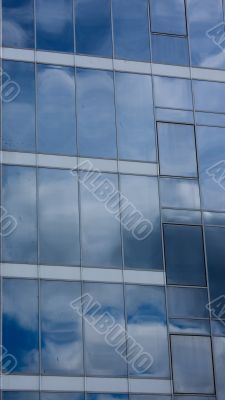 Sky and clouds reflected in modern window