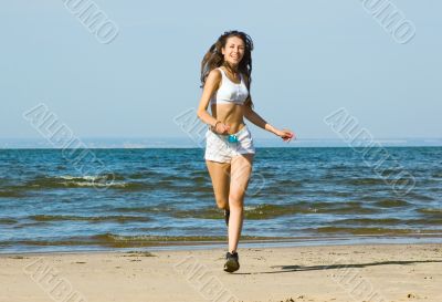 Young woman running alone on the beach