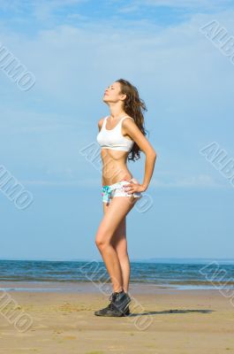 Young beautiful woman is relaxing on the beach
