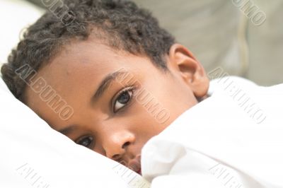 Boy resting in his bed