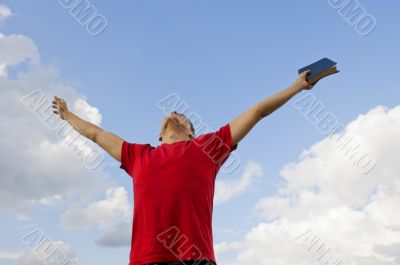 Young man staying with raised hands 