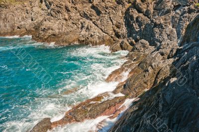 Storm waves roll and break on rocks