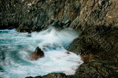 waves roll over the rocks