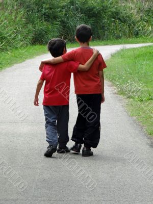 two children walking along a path two children walking along a path