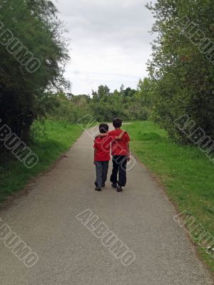 two boys walking along a path