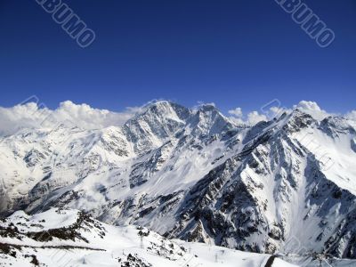 Mountain under the blue sky and the clouds