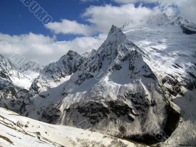 Mountain under the blue sky and the clouds