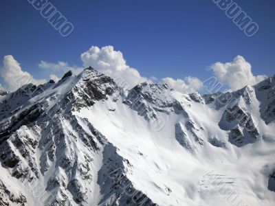 Mountain under the blue sky and the clouds