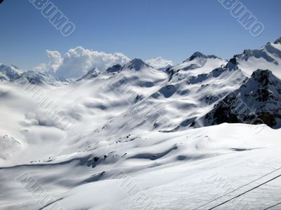 Mountain under the blue sky and the clouds