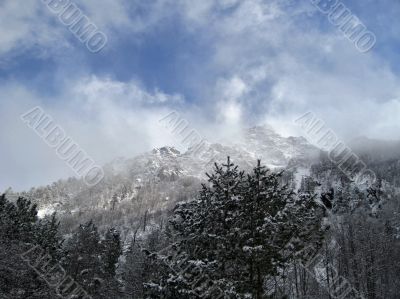 Mountain under the blue sky and the clouds