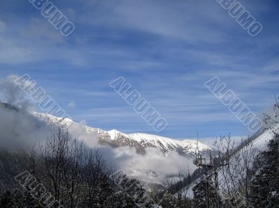 Mountain under the blue sky and the clouds