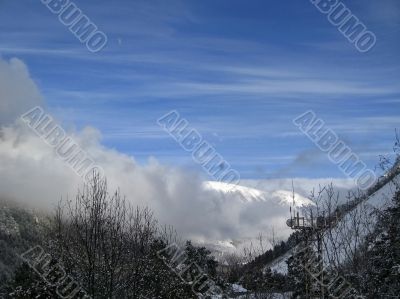 Mountain under the blue sky and the clouds