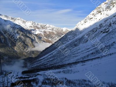 Mountain under the blue sky and the clouds